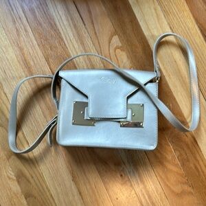 Mara’s leather bag, hand made in Taormina Italy. Gold leather with gold hardware